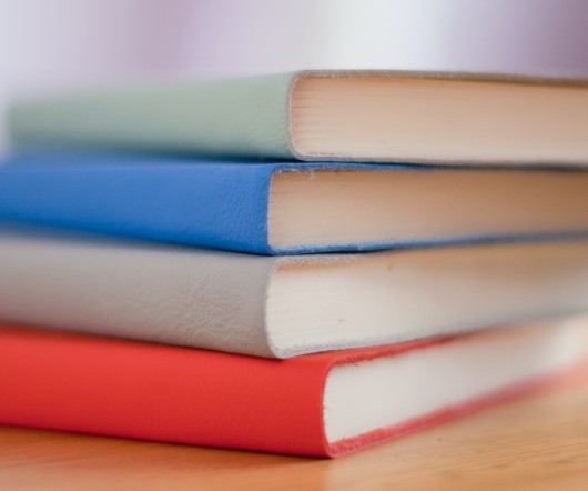 four colored books stacked up